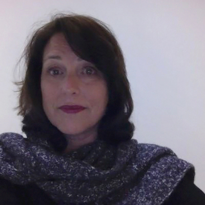 Betsy Linkedin photo (woman with brown hair wearing a shawl)